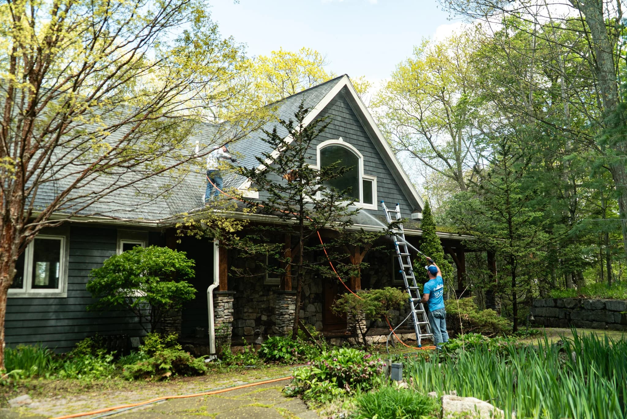 Six Mile crew cleaning the roofline of a Finger Lakes home