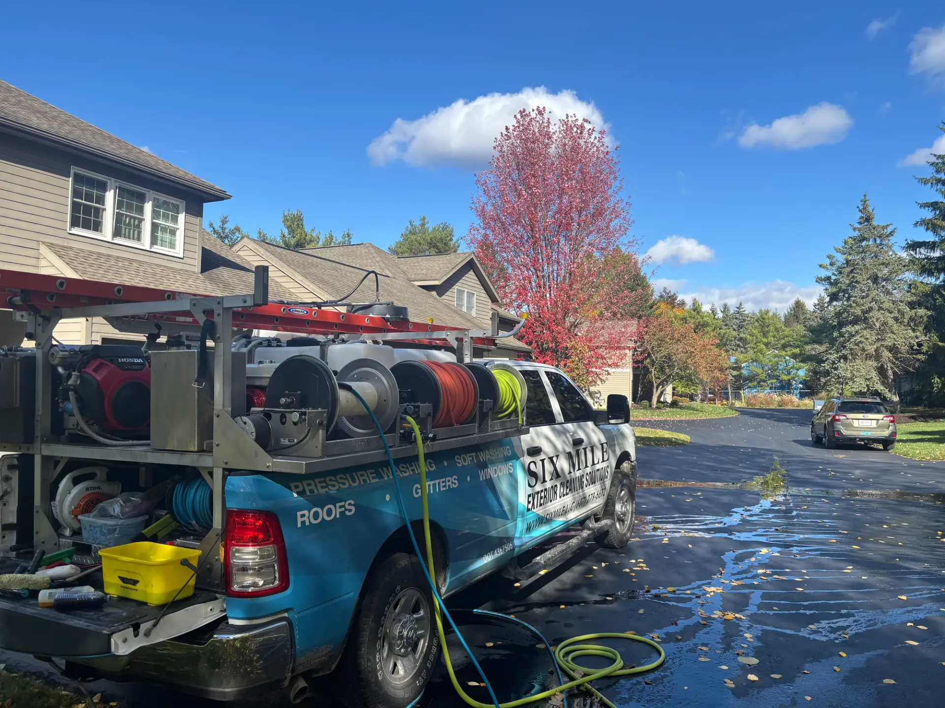 Six Mile branded truck parked for a fall gutter cleaning job