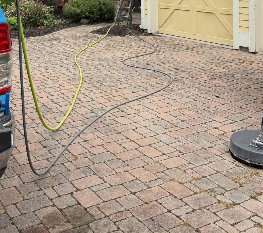 Dirt and algae built up on a paver driveway before power washing