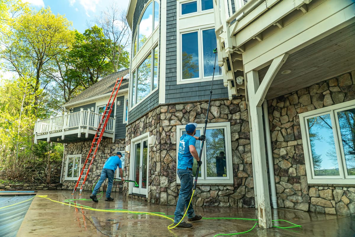 Six Mile crew soft washing the exterior of a stone and timber luxury home in the Finger Lakes