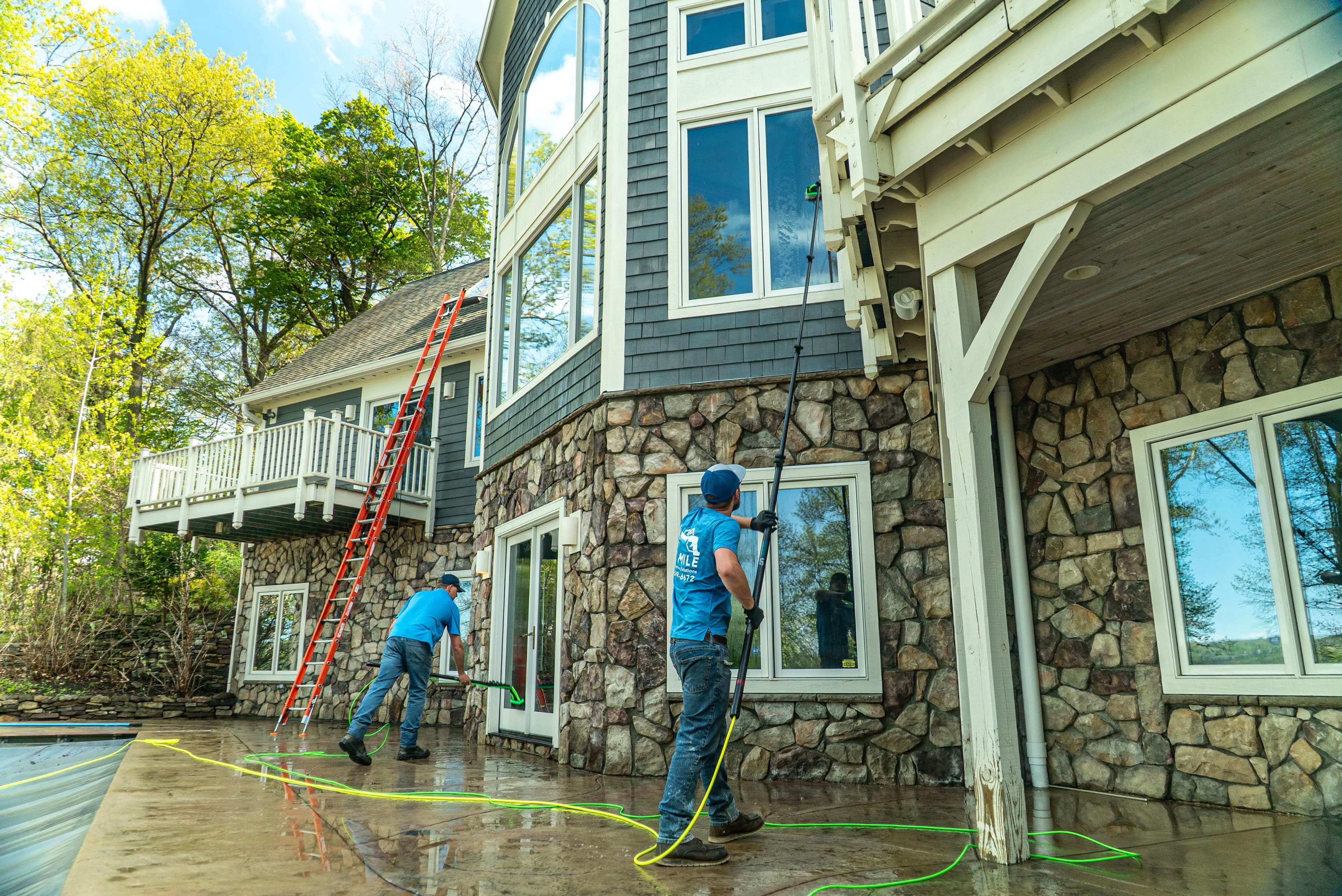 Six Mile crew soft washing the exterior of a stone and timber luxury home in the Finger Lakes