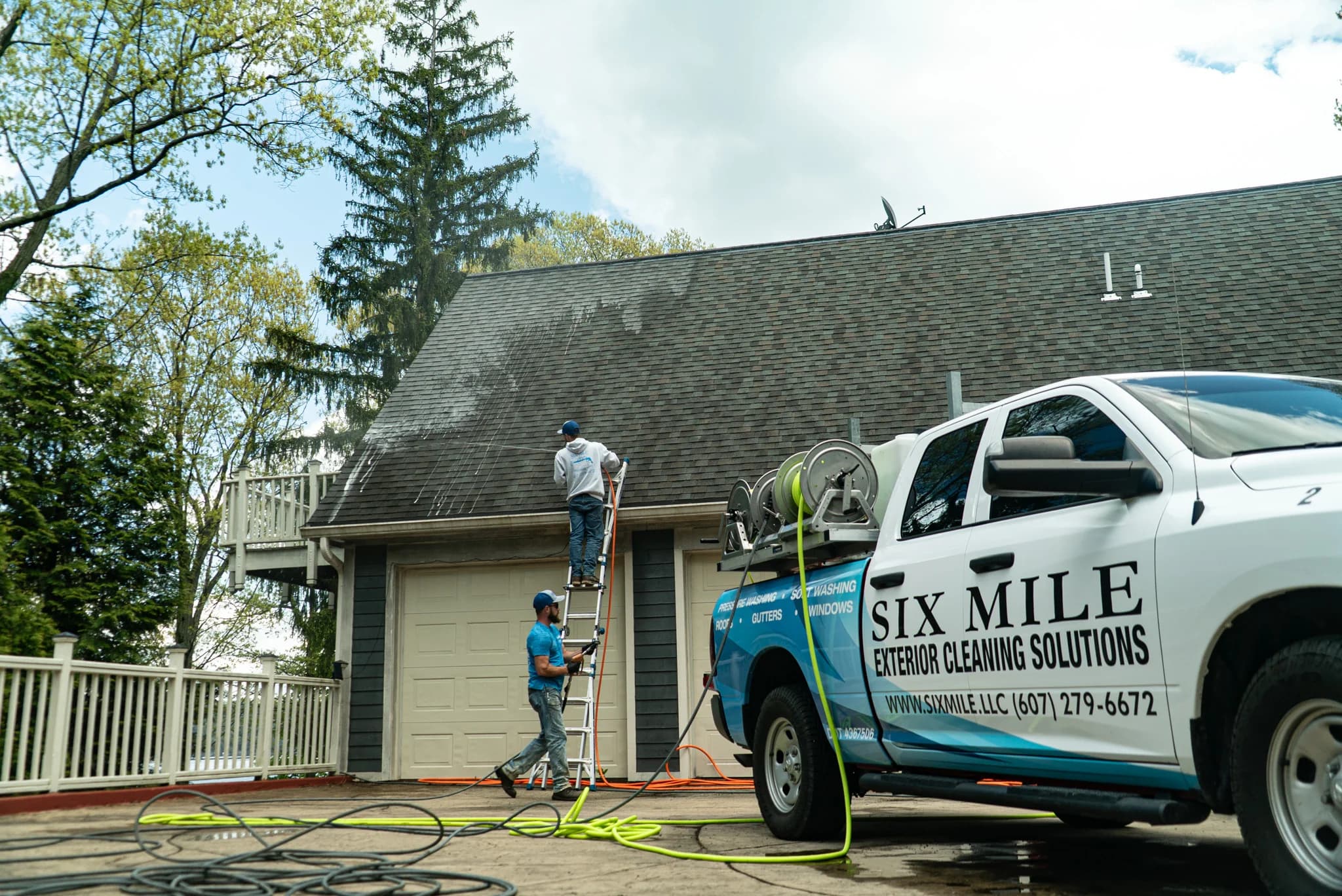 Six Mile crew removing rooftop moss at a home on Cayuga Lake in Trumansburg